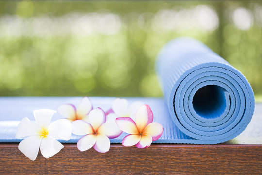 Blue Yoga Mat And A Flowers