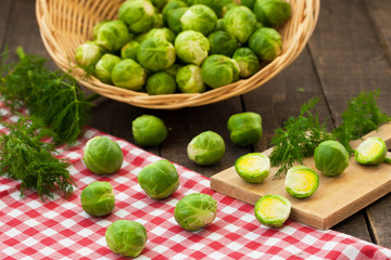 Brussels sprouts in basket and on rustic table