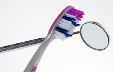 Toothbrush / toothbrush with dental mirror on grey background