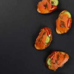Finger food canapes with smoked salmon and cream cheese. Selective focus.