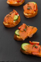 Finger food canapes with smoked salmon and cream cheese. Selective focus.