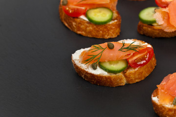 Finger food canapes with smoked salmon and cream cheese. Selective focus.