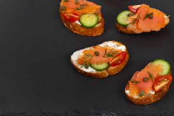 Finger food canapes with smoked salmon and cream cheese. Selective focus.
