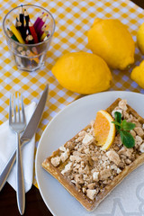 Waffles with meringue, lemon curls and orange slices