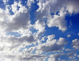 Blue sky with fluffy white clouds in day light