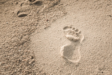 Fototapeta na wymiar Foot printed on sand beach.