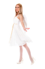 Beautiful young woman in a white dress with angel wings