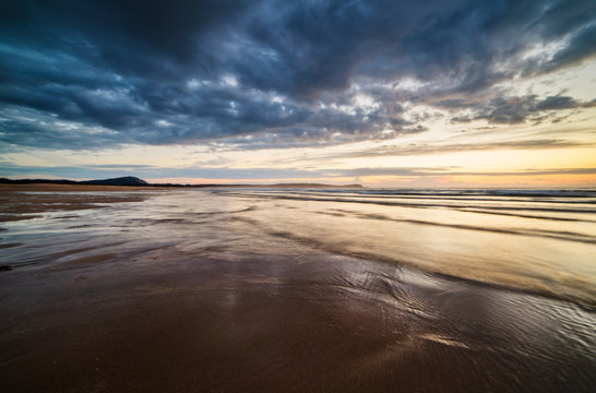 Beach at sunset in a stormy day © ramonespelt