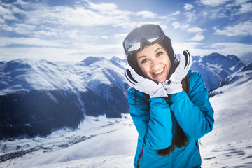 Fototapeta na wymiar Smiling girl blue jacket alps mountain resort