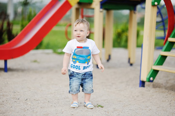 baby boy on the background of the playground