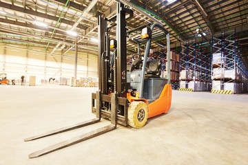 forklift loader stacker truck at warehouse © Kadmy