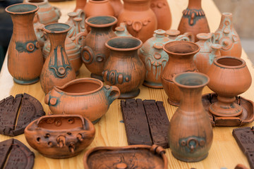 Fototapeta na wymiar Hand made clay pots with ornaments close up