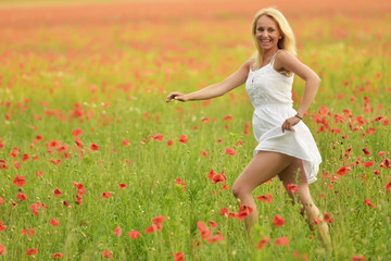 happy pregnant woman in poppie field