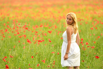 happy pregnant woman in poppie field