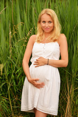 happy pregnant woman in poppie field