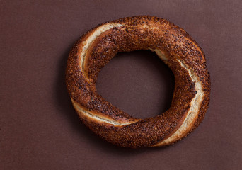 Simit (Turkish bagel) on brown background