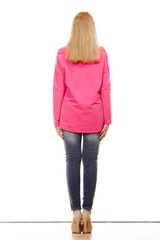 Obraz premium woman in denim pants pink blouse back view