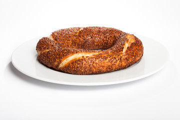 Simit (Turkish bagel) on white plate