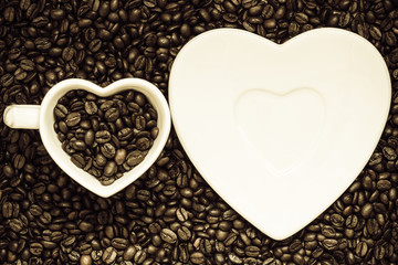 cup and saucer on coffee beans background