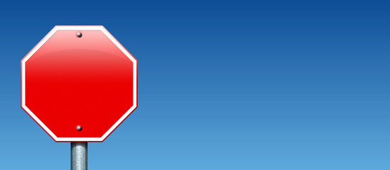 A blank stop sign against the blue sky.