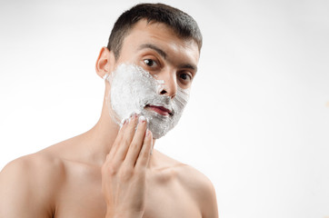 young man smears shaving gel on your face