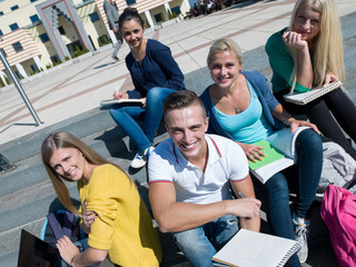 students outside sitting on steps