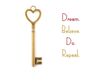 Gold heart shape key with inspirational phrase.