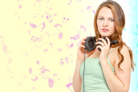 Conceptual young woman holds headphones