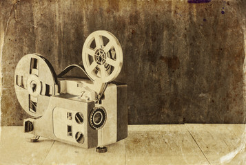 old 8mm Film Projector over wooden table
