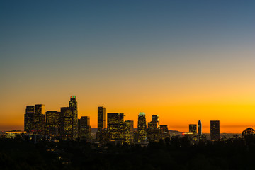View of downtown Los Angeles at golden hour  with the lights on.