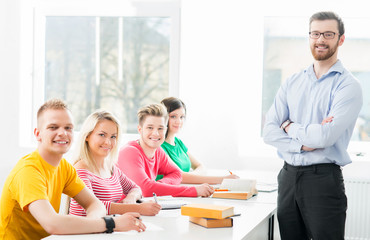 Group of teenage students studying at the lesson in the classroom