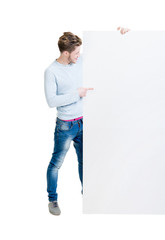 Happy teenager holding a blank banner isolated on white