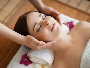 Young, beautiful and healthy woman in spa salon. Traditional oriental massage therapy and beauty treatments.