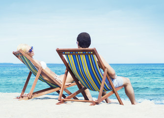 Man and woman chilling on a summer beach