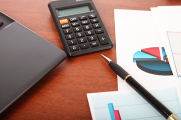 Calculator, laptop and financial documents