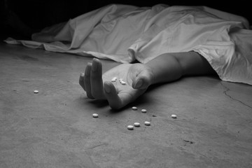 Close-up on the floor of the drugs in hand of the dead body. In