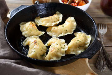 Dumplings with potatoes in a frying pan