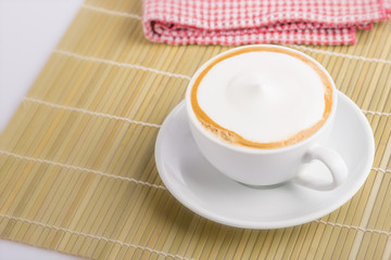 cup of cappuccino , hot milk soft relaxing.