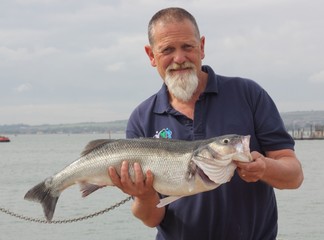 A fisherman with his rod caught specimen seabass of 9lb 11oz