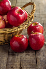 Red apples with picnic basket