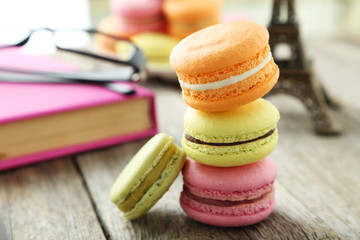 French colorful macarons on grey wooden background