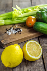 Lemons and vegetables on table