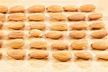 Almonds lie on a wooden table