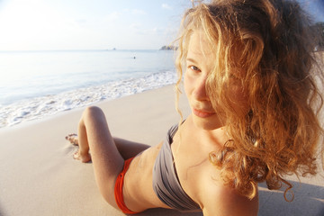 blonde sunbathing on the beach