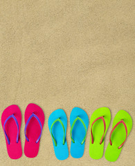 Fototapeta na wymiar Flip-flops on sand
