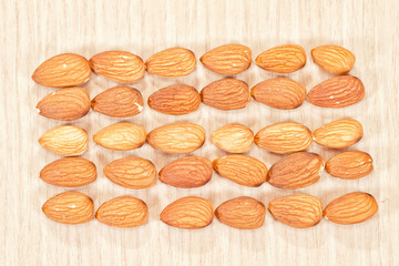 Almonds lie on a wooden table