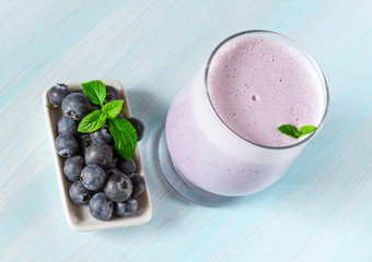 Milk cocktail with ripe blueberries.
