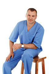 Portrait of a young male doctor in a medical surgical blue unifo