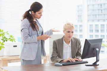 Businesswoman giving orders at her coworker