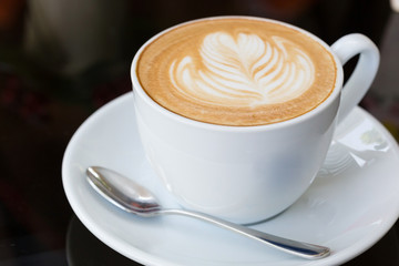 hot coffee latte, latte art with heart in a white cup